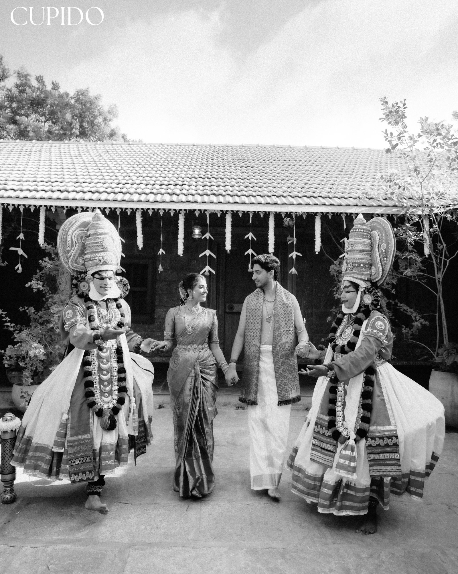 A wedding couple with traditional performers